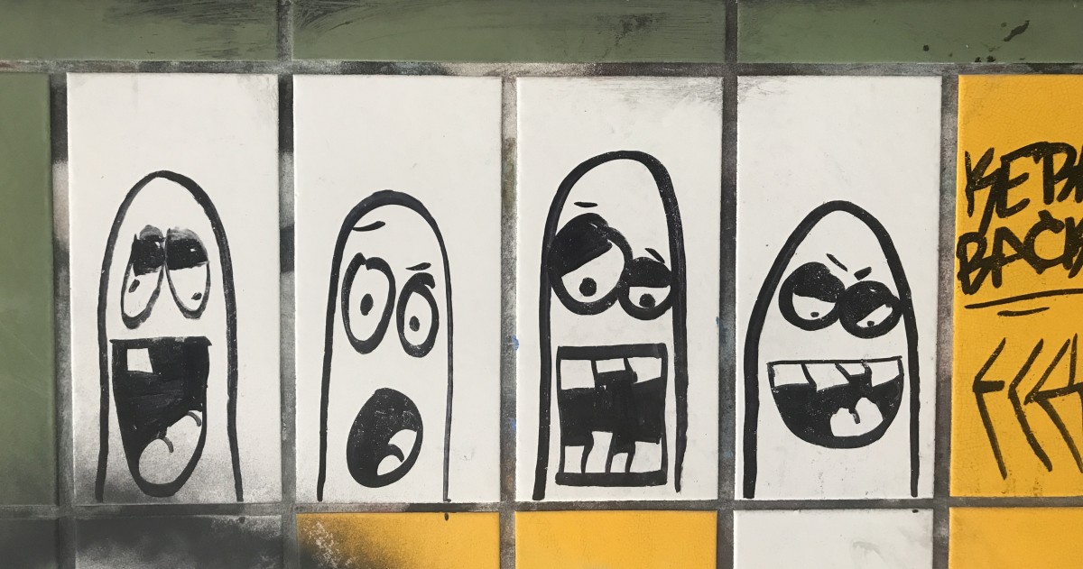 Berlin graffiti showing four unamused faces
